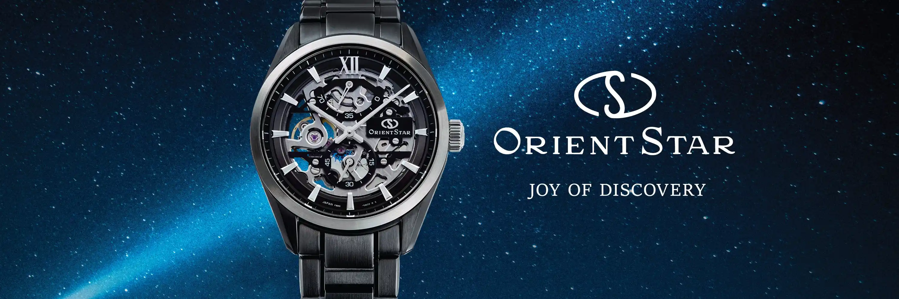 นาฬิกา Orient Star Skeleton หน้าปัดเปลือยรมดำ สายสเตนเลสสตีลสีดำ ฉากหลังทางช้างเผือกและห้วงอวกาศ Joy of Discovery